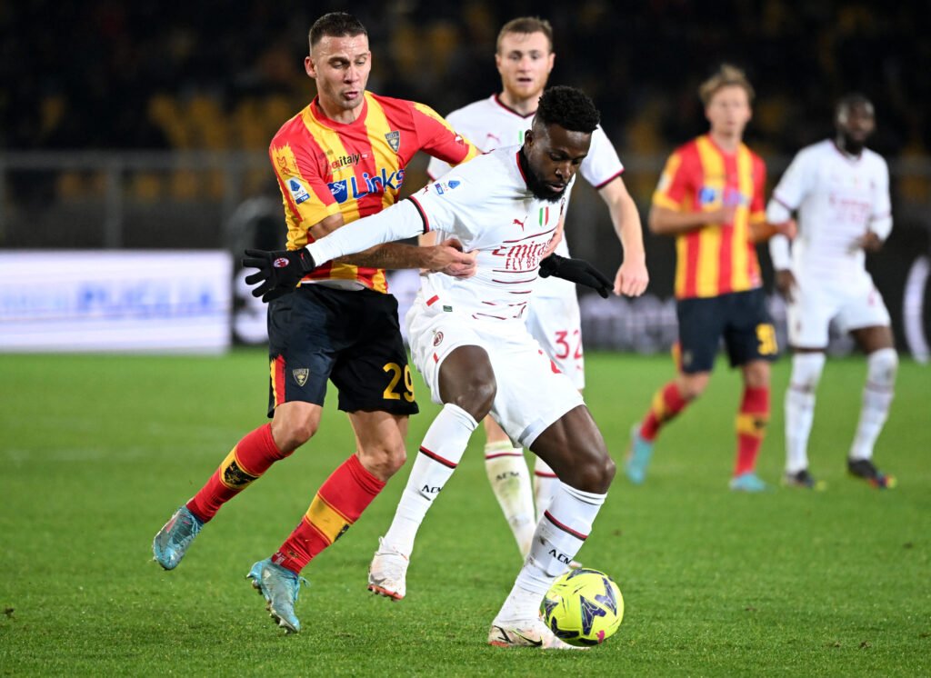 Lecce's Alexis Blin in action with AC Milan's Divock Origi