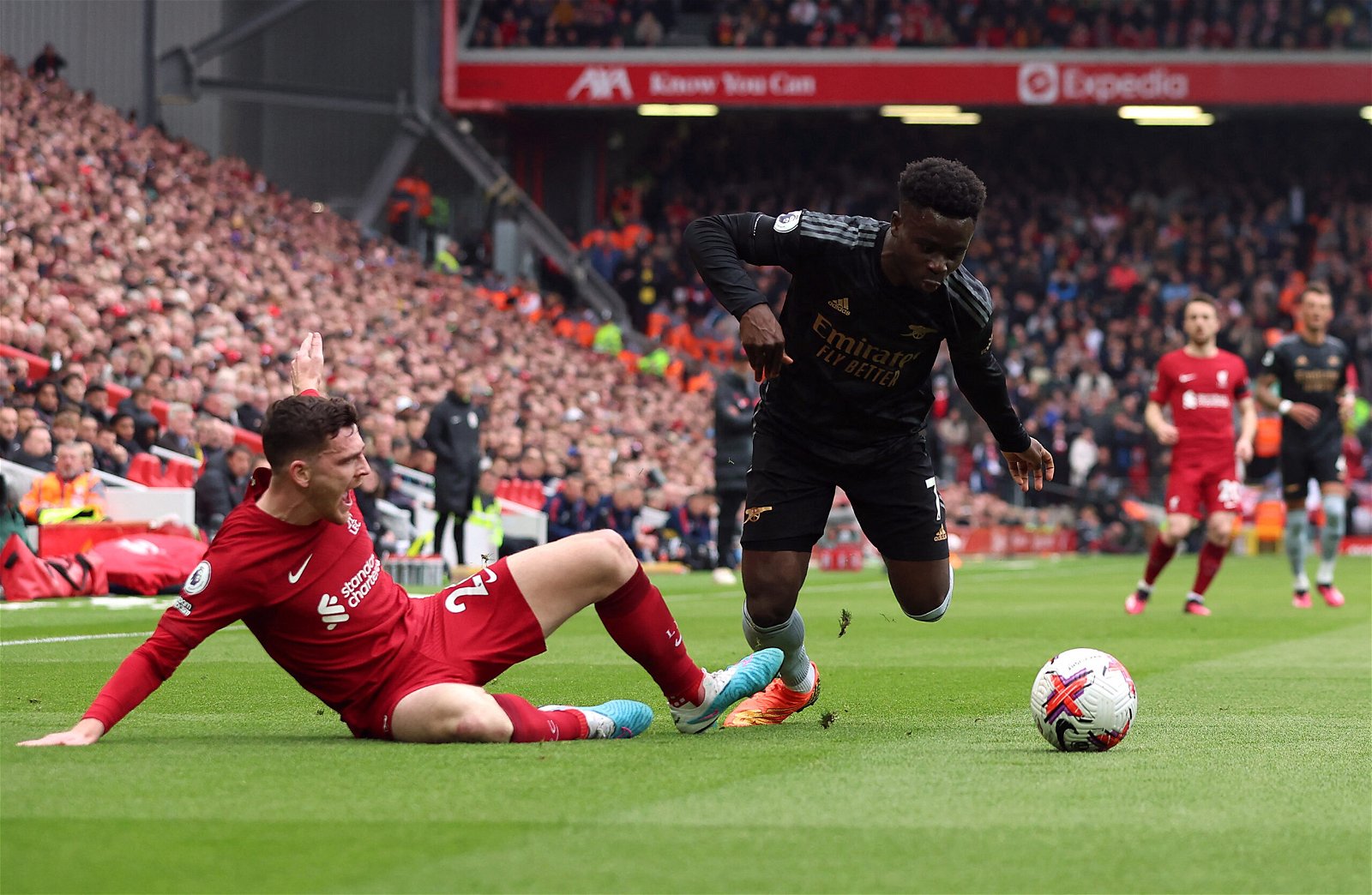 Liverpool's Andrew Robertson in action with Arsenal's Bukayo Saka