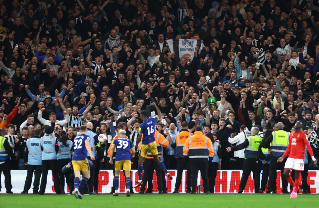 Newcastle United players celebrate with fans after the match