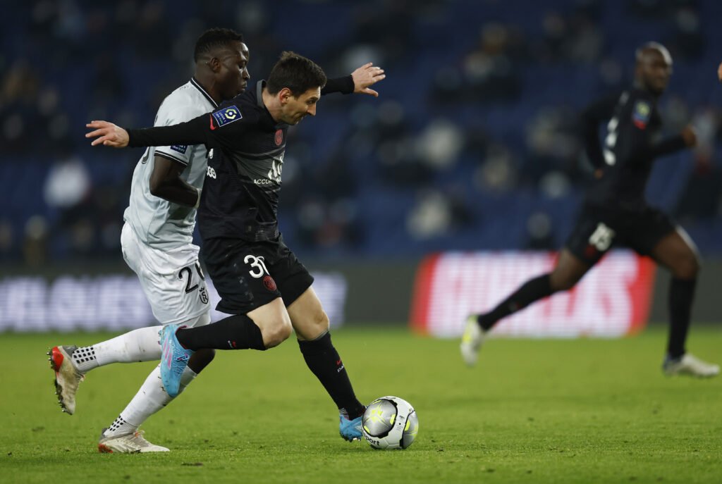 Paris St Germain's Lionel Messi in action Stade de Reims' Dion Lopy