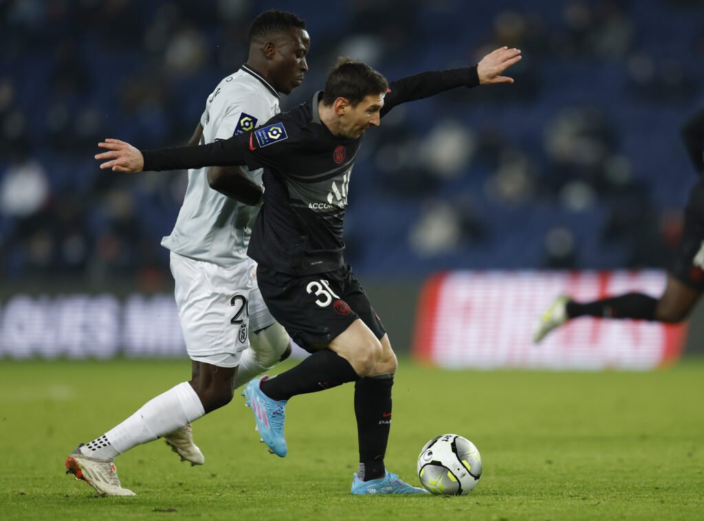 Paris St Germain's Lionel Messi in action Stade de Reims' Dion Lopy