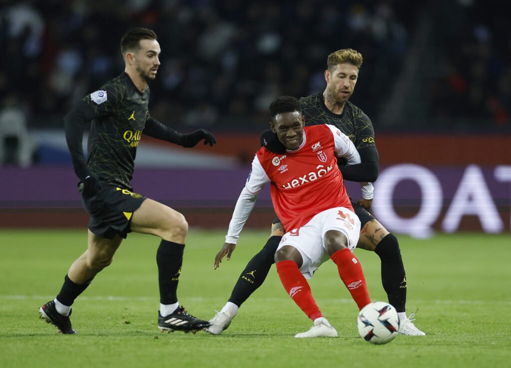 Stade de Reims' Folarin Balogun in action with Paris St Germain's Fabian Ruiz and Sergio Ramos 